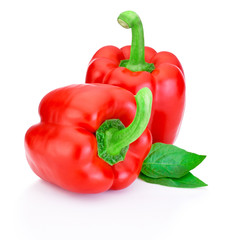 Two Red Peppers with green leaves isolated on white background