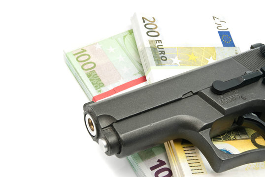 gun and banknotes on white