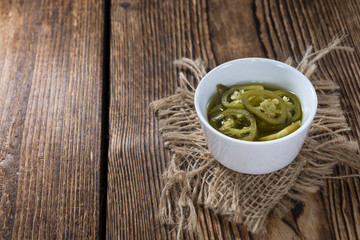 Jalapenos on wooden background