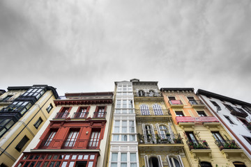 Fototapeta na wymiar Houses in Bilbao with athletic team flags