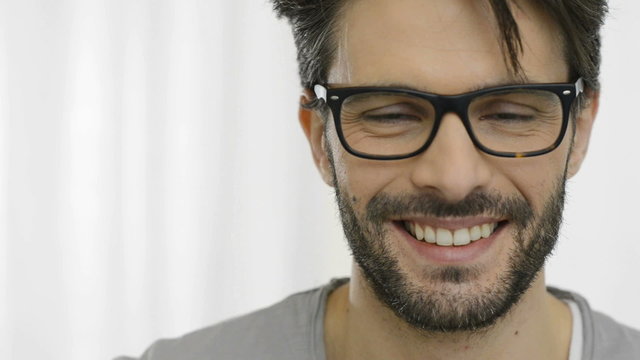 Laughing man wearing specs