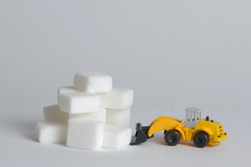 pyramid of sugar cubesv and bulldozer