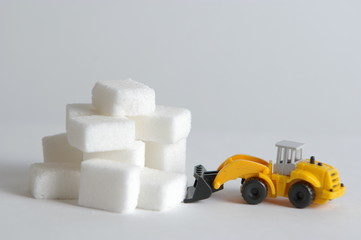 pyramid of sugar cubesv and bulldozer