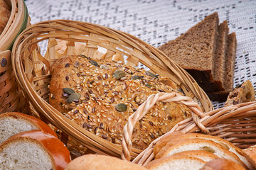 Plakat Wicker basket of bread on a tablecloth