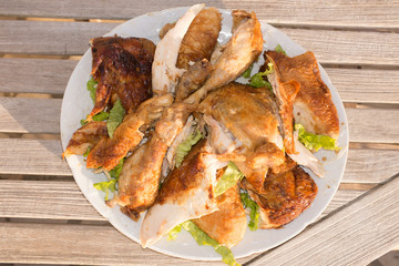 Piece of Roast chicken under wooden background