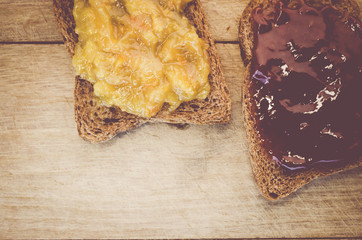 crisp bread with jam on a wood background