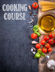 Cooking ingredients on blank dark board with cooking course sign