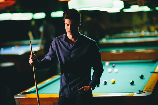 Young man playing pool