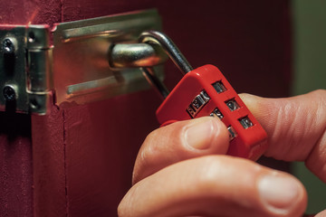 man trying to unlock combination lock