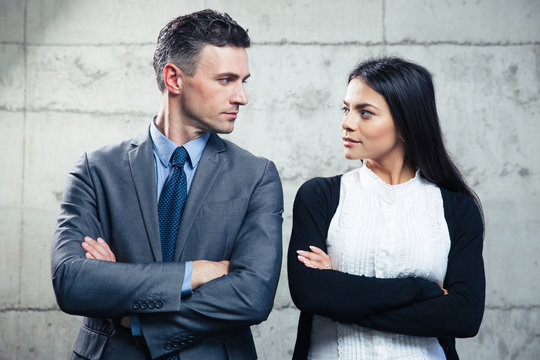 Businessman And Businesswoman Looking At Each Other