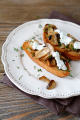 bruschetta with mushrooms on a white plate