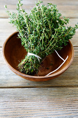 Fresh thyme in a bowl on wooden boards