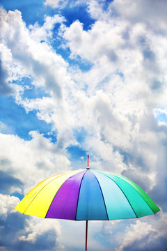 Colorful umbrella on sky background