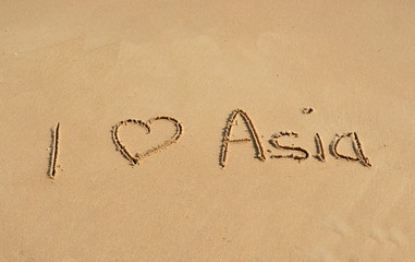 Text 'I love Asia' in the sand