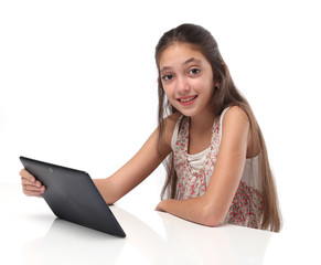Fototapeta premium Beautiful pre-teen girl with a tablet computer. Isolated. 