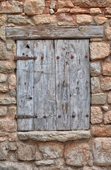 Closed Wood window on stone house