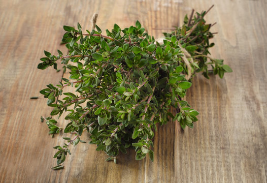 Thyme on  rustic wooden table.