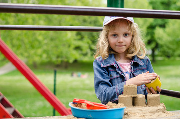 girl playing with sand