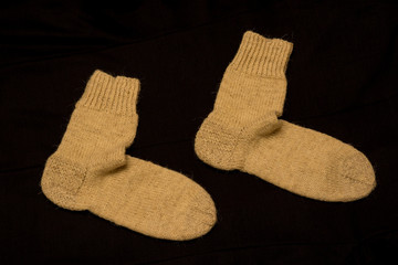Pair of Knitted Socks on Dark Background