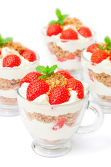 homemade desert with cream chopped cookies and fresh strawberry