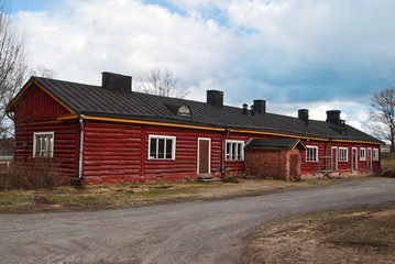 Fototapeta na wymiar The old Finnish manor of red logs.