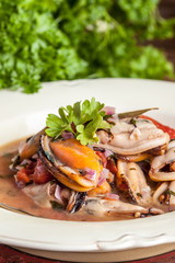 Cooked mussels in tomato sauce.