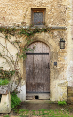 Fototapeta na wymiar Wooden door into a medieval building