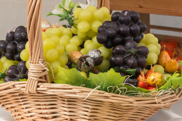 white and red bunch of grapes imitation in wicker basket