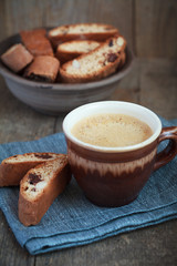 Cup of coffee and a handful of homemade biscotti with chocolate