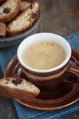 Cup of coffee and a handful of homemade biscotti with chocolate