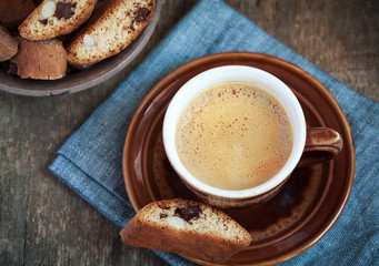 Cup of coffee and a handful of homemade biscotti with chocolate