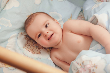 Little child baby smiling in bed