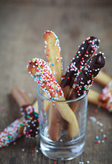 Naklejka premium Sweet bread sticks with chocolate and colorful sprinkles