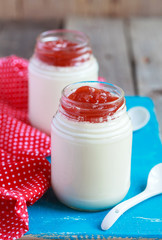 Homemade yogurt with apple jam in two small glass jars