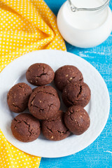 Italian chocolate cookies with walnuts and a jar of milk