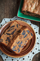 Cake with prunes and almond flour on a wooden table