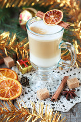 Hot coffee with milk in a glass on a wooden table 