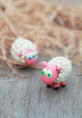 Obraz premium Plasticine world - little homemade white sheep stand on a farm
