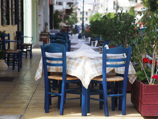 Fototapeta na wymiar Blue chairs on a greek cafe on Zakinthos 