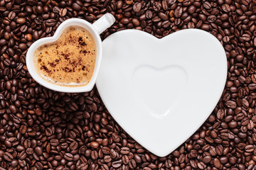 white coffee cup heart shaped with cappucino