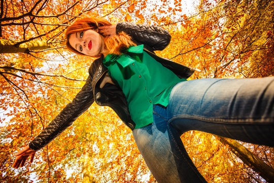 Unusual Angle Of Young Woman In Autumn Park