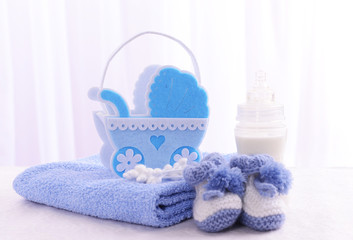 Baby accessories on table on light background