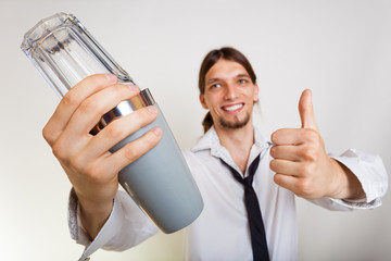 Happy man with shaker making cocktail drink