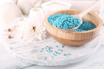 Spa still life with color sea salt on wooden table, closeup