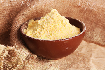 Bowl of whole flour on burlap cloth, closeup