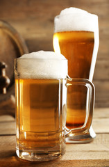 Glasses of beer on wooden background