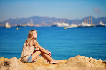 Young girl enjoying her vacation by the sea