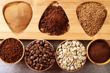 Various of coffee in small dishes on wooden table, top view