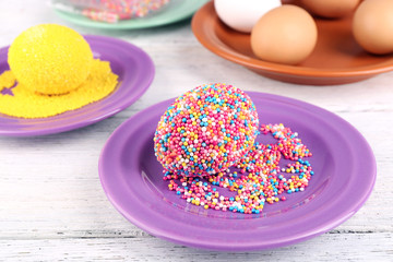 Decoration Easter eggs with colorful beads on wooden table, closeup
