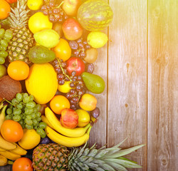 Huge group of fresh colorful fruit on wooden background - Health